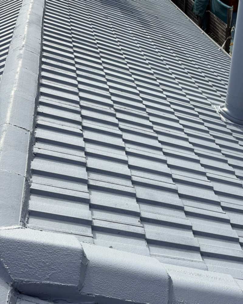 Coated concrete roof tiles and crisp ridge capping